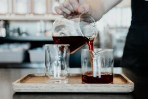 coffee being poured into a glass mug